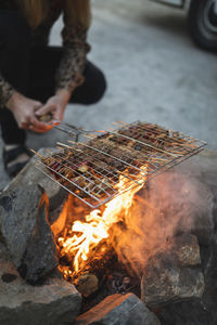 Low section of man preparing food during camping