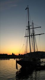 Boats in harbor at sunset