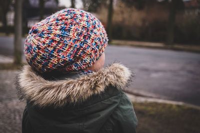 Rear view of woman wearing hat on street during winter