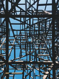 Low angle view of metallic structure against clear blue sky