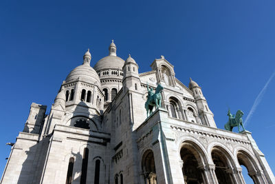 Low angle view of a building against blue sky