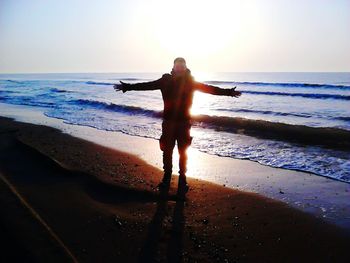 Full length of man on beach against clear sky