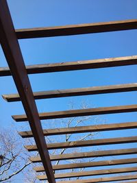 Low angle view of bridge against clear blue sky