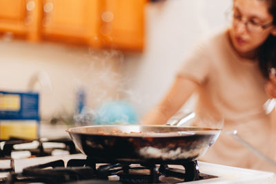 Woman preparing food in kitchen