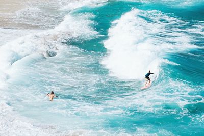 People surfing in sea