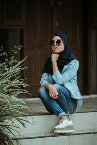 Portrait of a young woman sitting outdoors