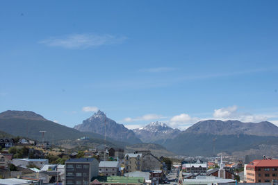 Houses on mountain against blue sky