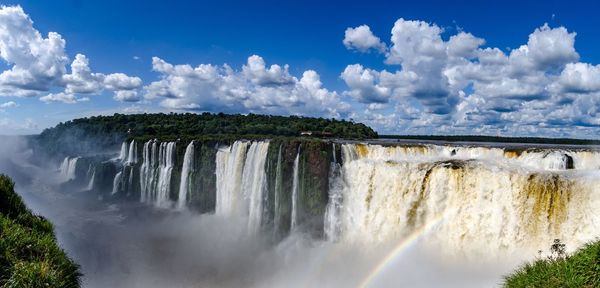 Scenic view of waterfall against sky