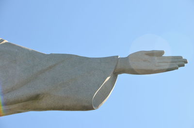 Low angle view of statue against clear blue sky