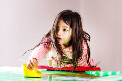 Portrait of a girl sitting on table