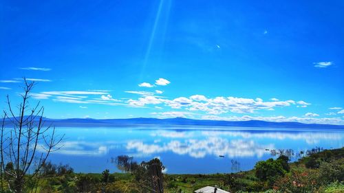 Scenic view of lake against blue sky