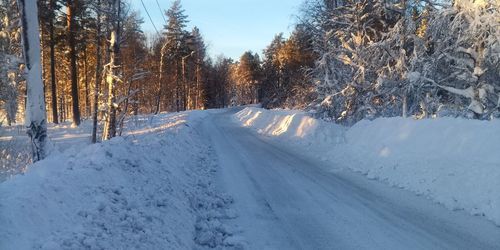 Snow covered land against sky