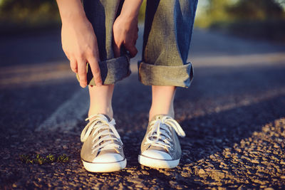 Low section of child standing on road