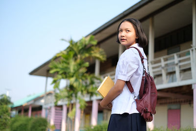 Teenage girl standing outdoors