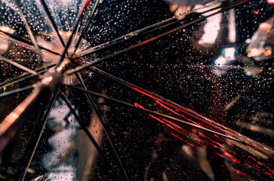 Close-up of wet glass against black background