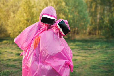 Portrait couple wearing virtual reality simulator on grassy field