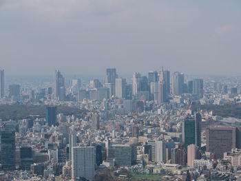 High angle view of modern buildings in city against sky