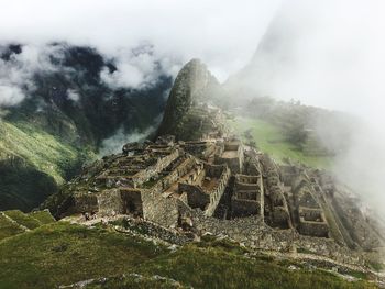 Old ruins on mountain in foggy weather