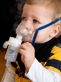 Close-up portrait of boy drinking water