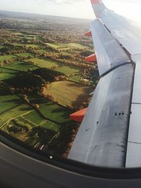 Aerial view of airplane wing over landscape