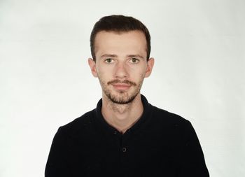 Portrait of young man against white background