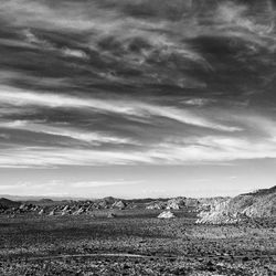 Scenic view of landscape against cloudy sky