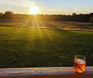 Scenic view of field against sky during sunset