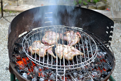 High angle view of meat on barbecue grill