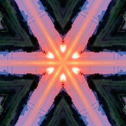 Digital composite image of illuminated trees against sky during sunset