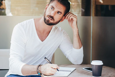 Portrait of young man working at home