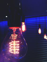 Close-up of lit candle in dark room