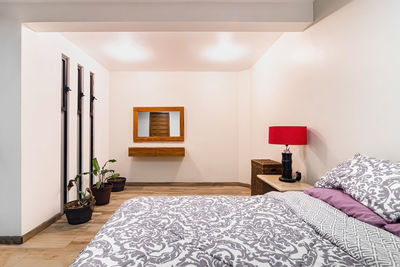 Bedroom, room, in the background you can see a bathroom, with mirrored sliding door, wooden door