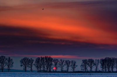 Scenic view of sea against romantic sky at sunset