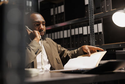 Young man using mobile phone in office