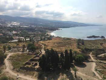 High angle view of sea and mountains against sky