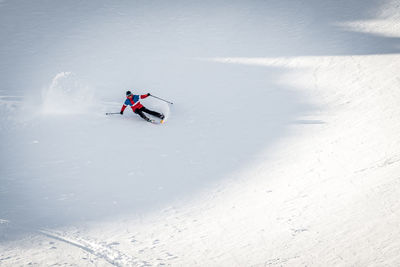 Man skiing on snow covered land