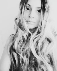 Portrait of beautiful woman against white background