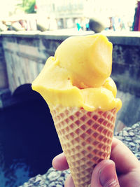 Cropped hand holding ice cream cone