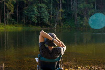 Solo man sit at side of lake with relax and wellbeing feel
