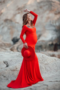 Midsection of woman with red hair standing outdoors