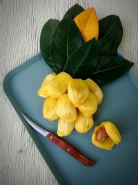 High angle view of yellow flowers on table