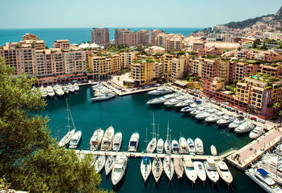 High angle view of city by sea against clear sky