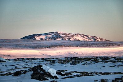 Scenic view of snowcapped mountains against sky during sunset