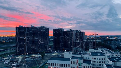High angle view of modern buildings against sky at sunset