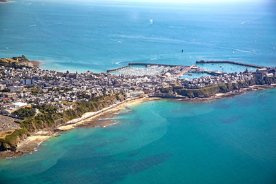 High angle view of sea and cityscape against sky