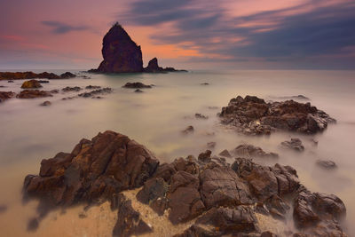 Scenic view of sea against cloudy sky