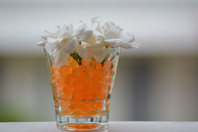 Close-up of orange glass on table