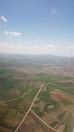 Aerial view of agricultural field against sky