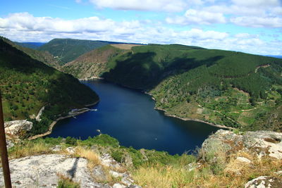 Scenic view of lake and mountains against sky