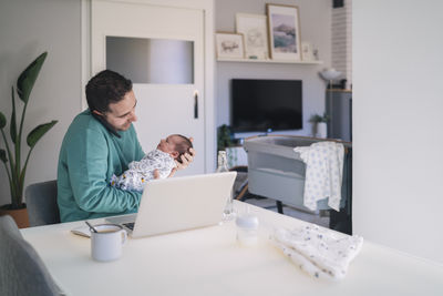 Men sitting on table at home